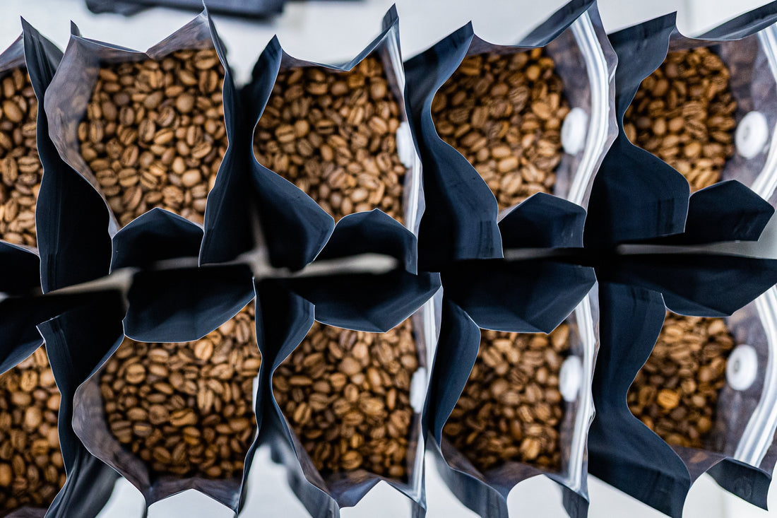 Fresh roasted coffee beans top view bags open