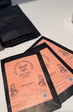 Load image into Gallery viewer, Three empty coffee bags with No Sleep Roastery branding and Ethiopia on the bags, displayed on a white surface.

