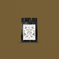 Fresh roasted coffee in a black bag with a designer label displayed on a bronze background