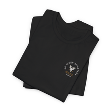 Load image into Gallery viewer, Merchandise folded black t-shirt with small company logo on the front
